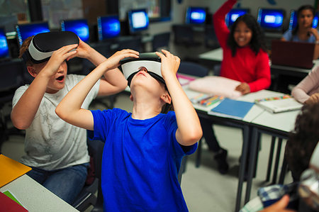 simsearch:6108-06905230,k - Curious junior high school boys using virtual reality simulators in classroom Stock Photo - Premium Royalty-Free, Code: 6113-09240372