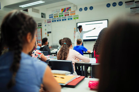 Junior high school students watching teacher give lesson at projection screen in classroom Stock Photo - Premium Royalty-Free, Code: 6113-09240387
