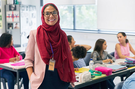 Portrait smiling, confident female teacher wearing hijab in classroom Stock Photo - Premium Royalty-Free, Code: 6113-09240394