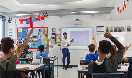 Junior high school students raising hands for teacher leading lesson in classroom Stock Photo - Premium Royalty-Free, Code: 6113-09240395