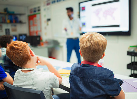 Junior high school boys watching teacher during lesson in classroom Stock Photo - Premium Royalty-Free, Code: 6113-09240420
