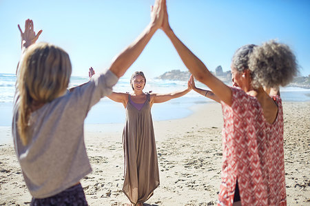 simsearch:649-07760822,k - Women joining hands in circle on sunny beach during yoga retreat Stock Photo - Premium Royalty-Free, Code: 6113-09240566