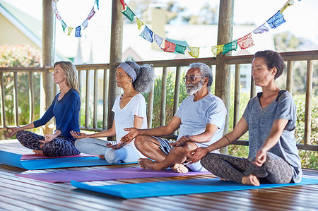 simsearch:6115-07539719,k - Serene people meditating in hut during yoga retreat Stock Photo - Premium Royalty-Free, Code: 6113-09240597