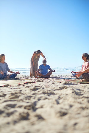 simsearch:6122-07705961,k - Serene people meditating on sunny beach during yoga retreat Stock Photo - Premium Royalty-Free, Code: 6113-09240599