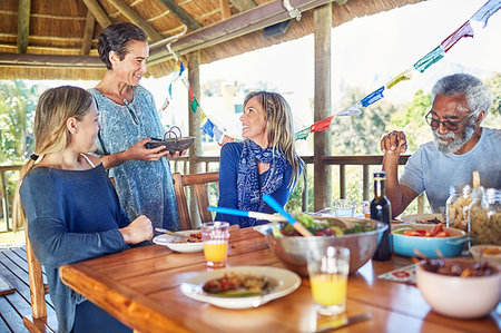 Friends enjoying healthy meal in hut during yoga retreat Stock Photo - Premium Royalty-Free, Code: 6113-09240608