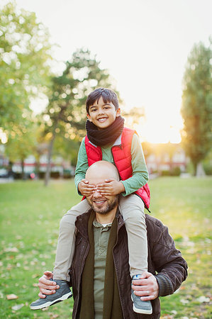 simsearch:649-06623087,k - Portrait playful son riding on fathers shoulders in autumn park Stock Photo - Premium Royalty-Free, Code: 6113-09240964