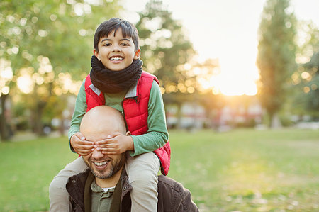 simsearch:649-06623087,k - Portrait playful son riding on fathers shoulders in autumn park Stock Photo - Premium Royalty-Free, Code: 6113-09240982