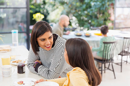 pic of indian kid eating breakfast - Mother and daughter talking, eating breakfast Stock Photo - Premium Royalty-Free, Code: 6113-09241081