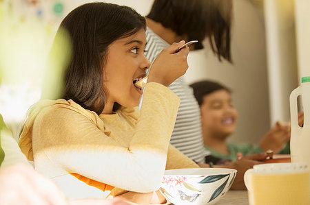 pic of indian kid eating breakfast - Girl eating breakfast cereal Stock Photo - Premium Royalty-Free, Code: 6113-09241023