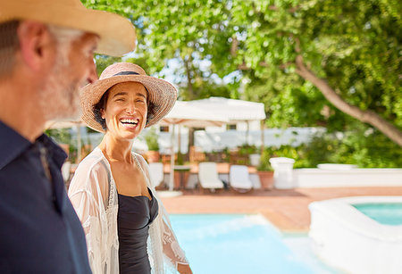 simsearch:6113-07242393,k - Happy mature couple at sunny resort poolside Stock Photo - Premium Royalty-Free, Code: 6113-09241173