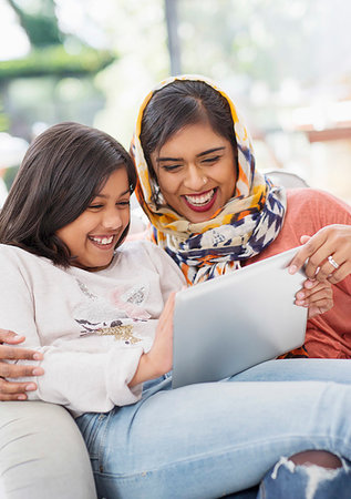 simsearch:649-06304951,k - Laughing, happy mother in hijab and daughter using digital tablet Stock Photo - Premium Royalty-Free, Code: 6113-09241100