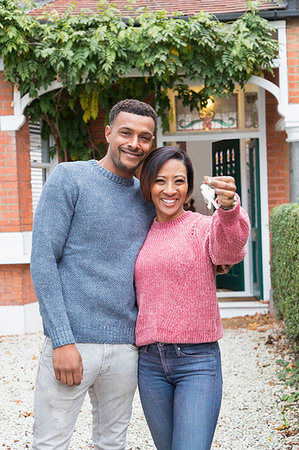 simsearch:632-05845211,k - Portrait happy couple holding house keys outside new house Stock Photo - Premium Royalty-Free, Code: 6113-09241273