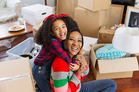 simsearch:6108-06167233,k - Portrait happy, enthusiastic mother and daughter hugging among boxes, moving house Photographie de stock - Premium Libres de Droits, Code: 6113-09241292