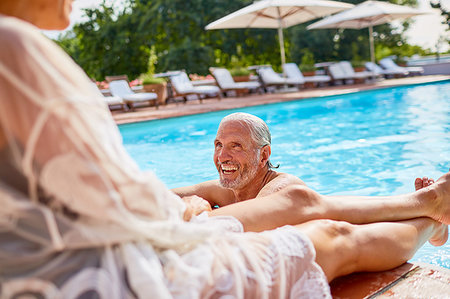 simsearch:6113-07242393,k - Happy couple relaxing at sunny resort swimming pool Stock Photo - Premium Royalty-Free, Code: 6113-09241209