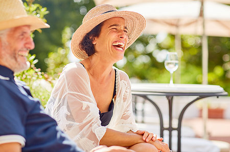 simsearch:6113-07242393,k - Woman laughing at sunny resort poolside Stock Photo - Premium Royalty-Free, Code: 6113-09241219