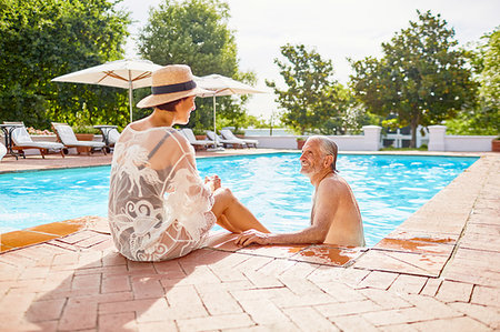 simsearch:6113-07242393,k - Happy mature couple relaxing at sunny resort swimming pool Stock Photo - Premium Royalty-Free, Code: 6113-09241221