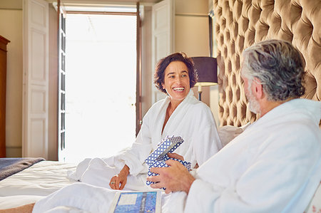 simsearch:6113-07242393,k - Happy mature couple in bathrobes on bed Stock Photo - Premium Royalty-Free, Code: 6113-09241228