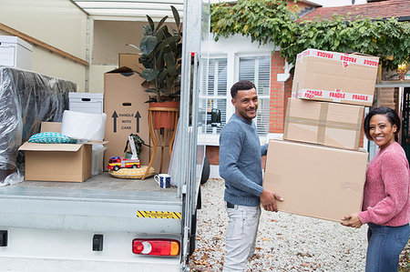 simsearch:632-05845211,k - Portrait happy couple moving house, unloading cardboard boxes from moving van Stock Photo - Premium Royalty-Free, Code: 6113-09241324