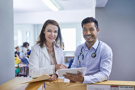 Portrait confident doctors with digital tablet in clinic Stock Photo - Premium Royalty-Free, Code: 6113-09241600