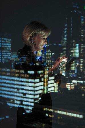 simsearch:6118-08243810,k - Double exposure businesswoman with smart phone against highrise lights at night Stock Photo - Premium Royalty-Free, Code: 6113-09272428