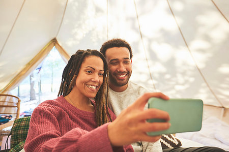 simsearch:632-07674444,k - Happy couple taking selfie in camping yurt Stock Photo - Premium Royalty-Free, Code: 6113-09272760