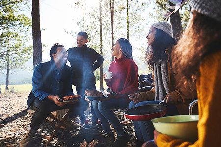 simsearch:846-02793585,k - Family and friends eating at sunny campsite in woods Stock Photo - Premium Royalty-Free, Code: 6113-09272867