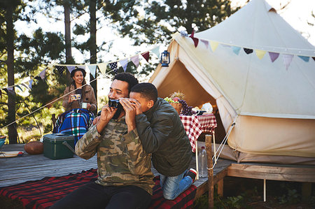 simsearch:6113-06720252,k - Curious father and son using binoculars outside yurt at campsite Stock Photo - Premium Royalty-Free, Code: 6113-09272872