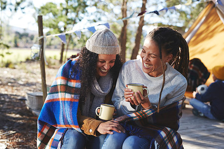 simsearch:6113-07589470,k - Happy, carefree lesbian couple laughing, drinking coffee at campsite Stock Photo - Premium Royalty-Free, Code: 6113-09272832