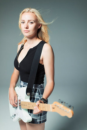 simsearch:614-06719795,k - Portrait confident, cool young woman playing electric guitar Stock Photo - Premium Royalty-Free, Code: 6113-09200038