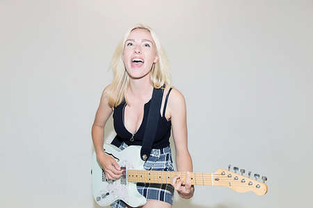 simsearch:614-06719795,k - Exuberant young woman playing electric guitar Stock Photo - Premium Royalty-Free, Code: 6113-09220492