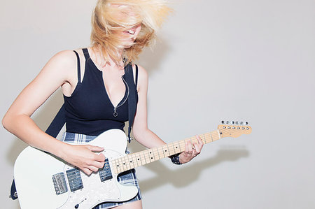 simsearch:614-06719795,k - Exuberant young woman playing electric guitar Stock Photo - Premium Royalty-Free, Code: 6113-09220574