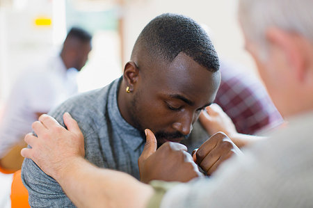 simsearch:649-06717849,k - Man comforting young man in group therapy Stock Photo - Premium Royalty-Free, Code: 6113-09220750