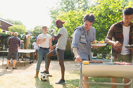 football in the backyard - Male friends enjoying barbecue in sunny summer backyard Stock Photo - Premium Royalty-Free, Code: 6113-09239761