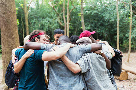 senior in a huddle - Men friends hugging in huddle on hike in woods Stock Photo - Premium Royalty-Free, Code: 6113-09239792