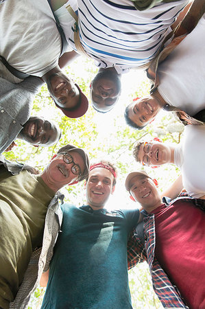 senior in a huddle - View from below mens group standing in huddle Stock Photo - Premium Royalty-Free, Code: 6113-09239799