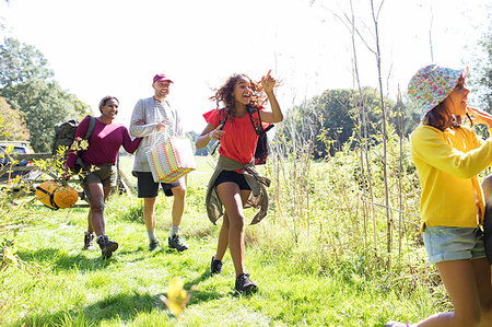 simsearch:6113-07159174,k - Eager family carrying camping equipment in sunny field Stock Photo - Premium Royalty-Free, Code: 6113-09239857