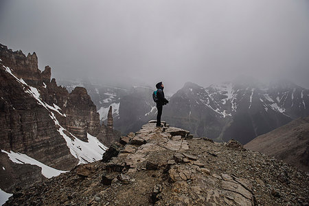 simsearch:614-06625125,k - Female hiker on top of craggy, foggy mountain Banff, Alberta, Canada Stock Photo - Premium Royalty-Free, Code: 6113-09239818