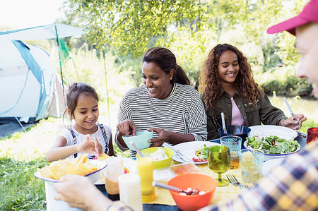 simsearch:695-05774517,k - Happy family enjoying lunch at campsite table Photographie de stock - Premium Libres de Droits, Code: 6113-09239981