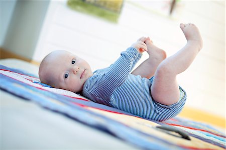 simsearch:6115-06778553,k - Baby boy lying on back, Munich, Bavaria, Germany Stock Photo - Premium Royalty-Free, Code: 6115-06778547