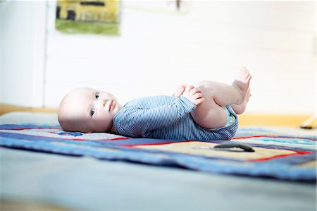 simsearch:6115-07539732,k - Baby boy lying on back, Munich, Bavaria, Germany Stock Photo - Premium Royalty-Free, Code: 6115-06778546