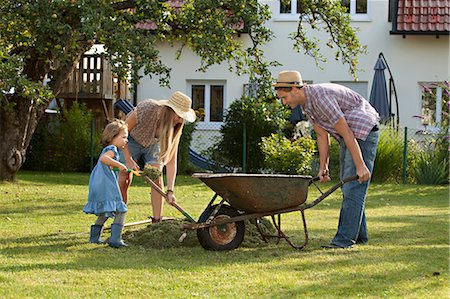 family gardening - Family with one child working together in garden, Munich, Bavaria, Germany Stock Photo - Premium Royalty-Free, Code: 6115-06778608