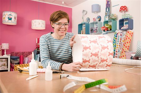 Woman Showing A Custom Lampshade, Munich, Bavaria, Germany, Europe Stock Photo - Premium Royalty-Free, Code: 6115-06778841