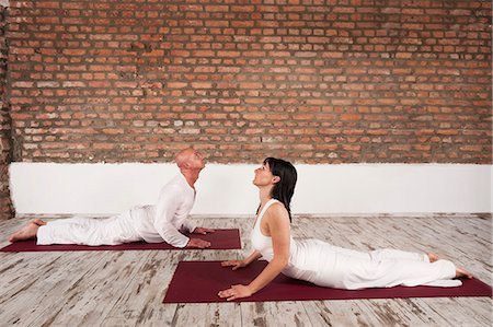 Couple Practising Yoga, Cobra Pose Stock Photo - Premium Royalty-Free, Code: 6115-06778902