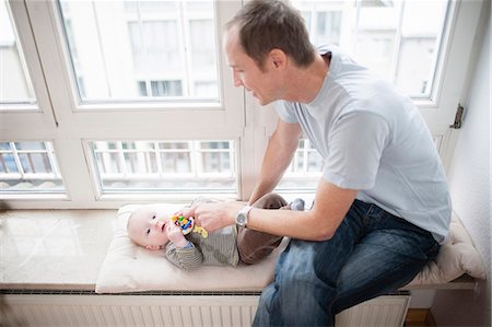 simsearch:6115-07539732,k - Young father with baby, Munich, Bavaria, Germany Stock Photo - Premium Royalty-Free, Code: 6115-06779093