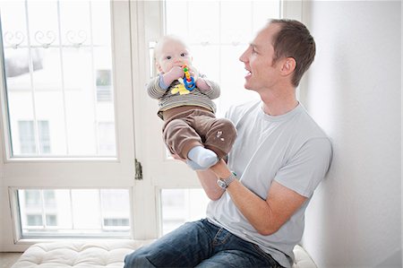 simsearch:6115-07539732,k - Father with baby in his arms, Munich, Bavaria, Germany Stock Photo - Premium Royalty-Free, Code: 6115-06779092
