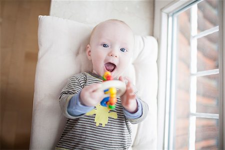 simsearch:6115-07539732,k - Baby boy playing with rattle, Munich, Bavaria, Germany Stock Photo - Premium Royalty-Free, Code: 6115-06779095