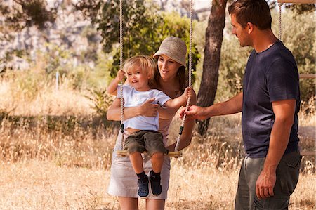 simsearch:6115-07539774,k - Croatia, Dalmatia, Parents playing with child on swing Stock Photo - Premium Royalty-Free, Code: 6115-06732828