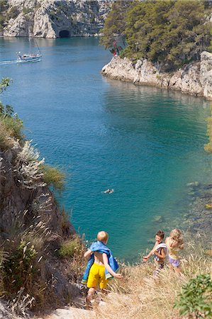 Croatia, Dalmatia, Children in swimwear playing by the seaside Stock Photo - Premium Royalty-Free, Code: 6115-06732834