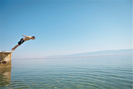 Croatia, Young man diving into the water Stock Photo - Premium Royalty-Free, Code: 6115-06732978