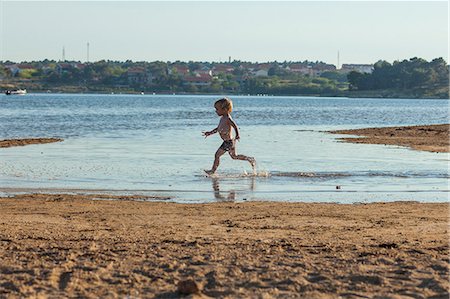 Croatia, Dalmatia, Little Boy Playing On Beach Stock Photo - Premium Royalty-Free, Code: 6115-06732904